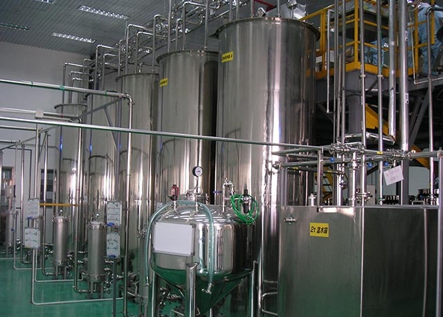 Large stainless steel storage and processing tanks in a food plant